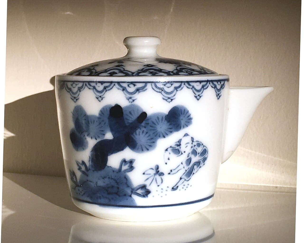 An antique small sencha kyusu, Arita ware from the Eiyama kiln, with a blue-and-white karako (children at play) motif, dating to the early Showa or Taisho era