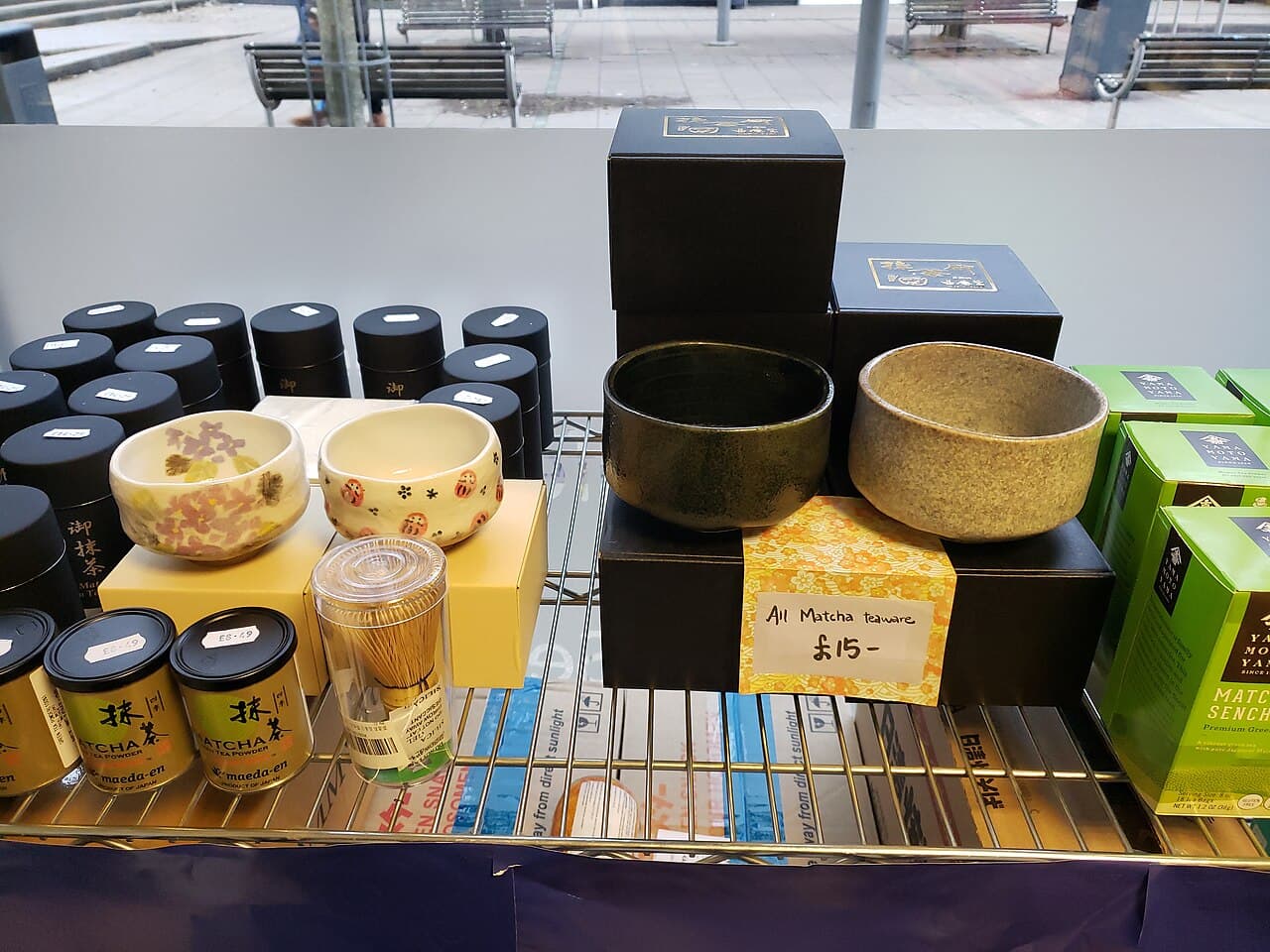 Multiple commercial matcha tins on a shelf (generic display, not the specific brands reviewed)
