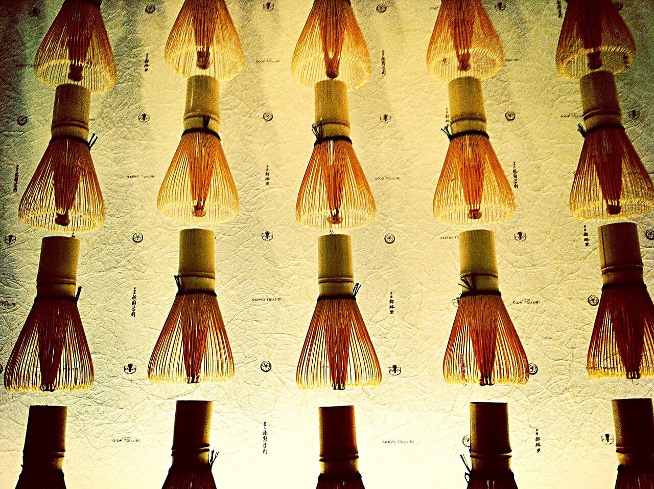 Bamboo chasen tea whisks displayed in Kyoto, Japan, showing the fine hand-split tines
