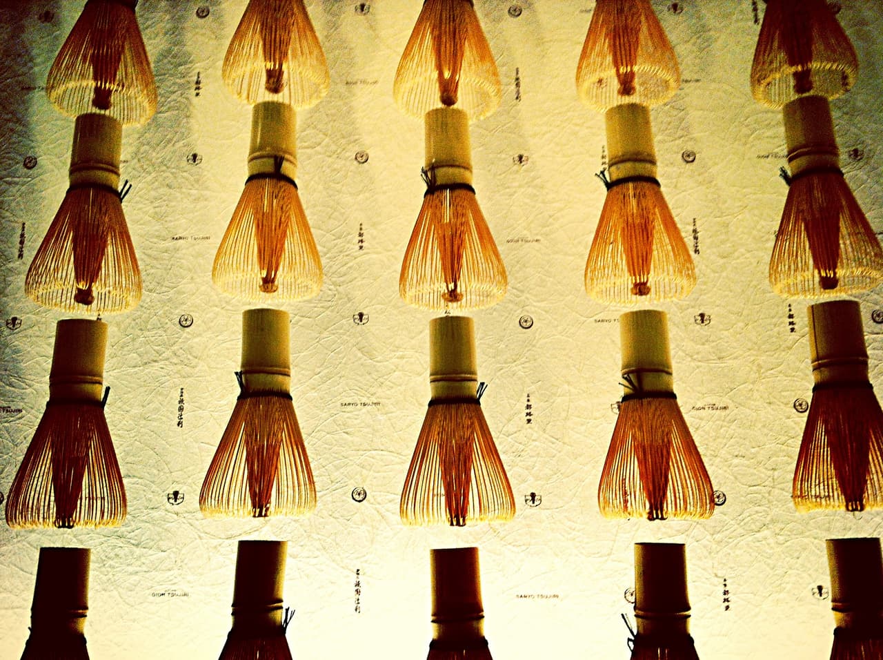 Bamboo chasen tea whisks displayed in Kyoto, Japan, showing the fine hand-split tines